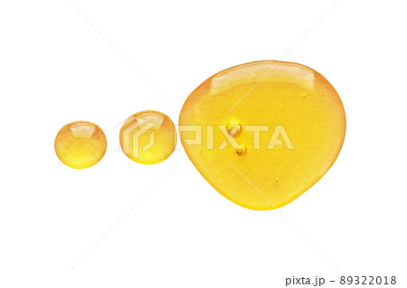 Golden yellow abstract oil bubbles or face serum drops isolated on white background. Oil bubbles macro photography. Golden yellow abstract oil bubbles or face serum drops isolated on white background. Oil bubbles macro photography. 89322018
