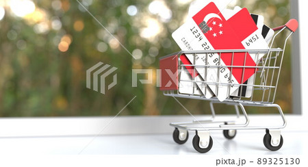 Credit card mockups with flags of Singapore in a small shopping cart. 3D rendering Credit card mockups with flags of Singapore in a small shopping cart. 3D rendering 89325130