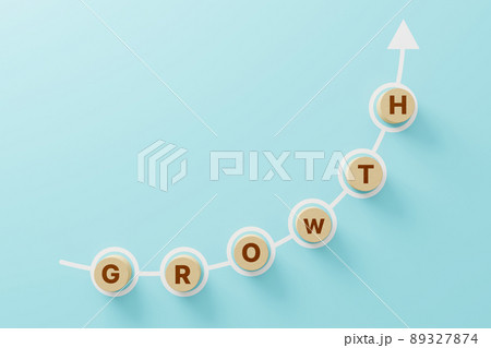 Wooden cube block on light blue background with word GROWTH and copy space for your text 89327874