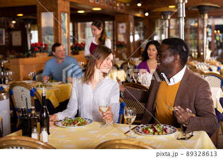 Portrait of a happy couple at a dinner in restaurant Portrait of a happy couple at a dinner in restaurant 89328613