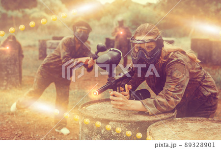 Portrait of girl in camouflage on paintball field Portrait of girl in camouflage on paintball field 89328901