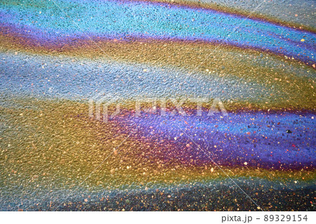 Oil stain on the asphalt, rainbow-shaped colored gasoline stains on an asphalt road 89329154