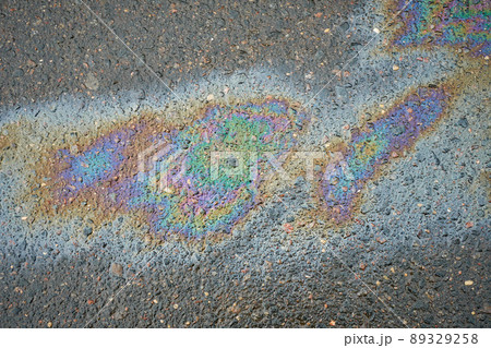 Rainbow gasoline oil spill on the pavement as a texture or background. 89329258