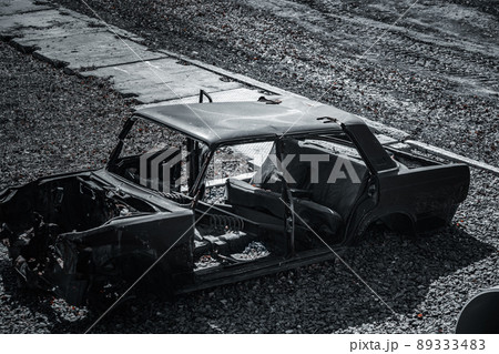 Remains of charred car after explosion or accident. View of frame of twisted machine. Broken 89333483