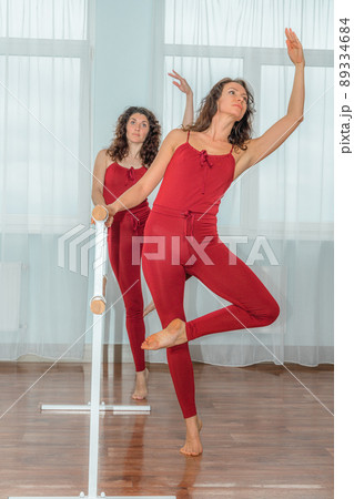 I train with a friend. Two young women train together in a bright training room near a choreographic machine. I train with a friend. Two young women train together in a bright training room near a choreographic machine. 89334684