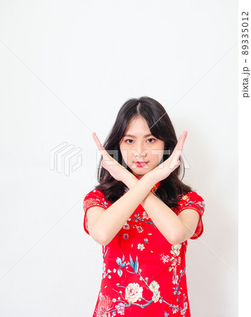 Portrait of Young asian woman wearing traditional cheongsam qipao dress crossed hands show no decline forbidden rule signal isolated over white background. Portrait of Young asian woman wearing traditional cheongsam qipao dress crossed hands show no decline forbidden rule signal isolated over white background. 89335012