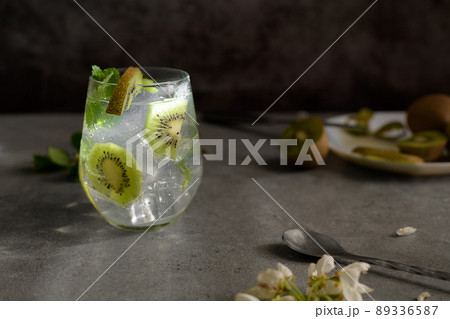 Kiwi mojito cocktail or caipirinha drink recipes with mint and ice in glasses close up. Summer cold drink kiwi lemonade 89336587