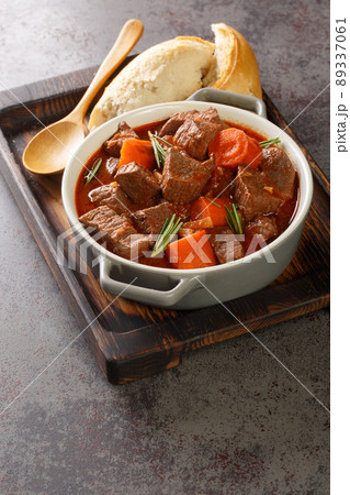 Daube Provencal French stew beef with vegetables is slow simmered to tenderness closeup in the wooden tray. Vertical 89337061