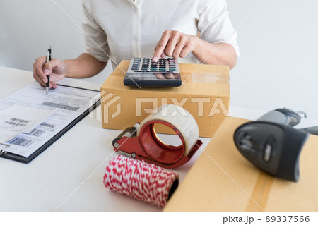 Small business owner delivery service and working packing box, business owner working checking order to confirm before sending customer in post office, Shipment Online Sales Small business owner delivery service and working packing box, business owner working checking order to confirm before sending customer in post office, Shipment Online Sales 89337566