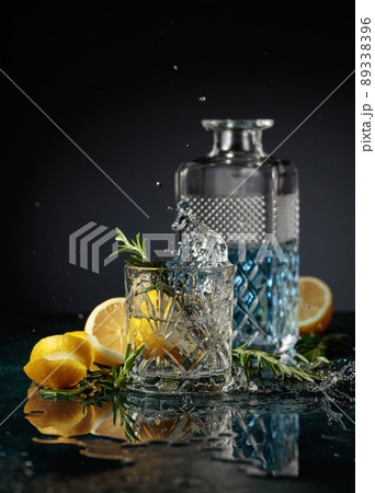 Gin tonic cocktail with lemon and rosemary. 89338396