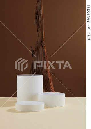 Front view of branch tree and white podium in brown background  89339511