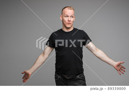 Confused Caucasian man with outstretched arms. 89339800