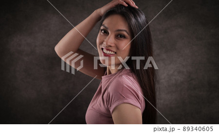 Happy young woman looks into the camera Happy young woman looks into the camera 89340605