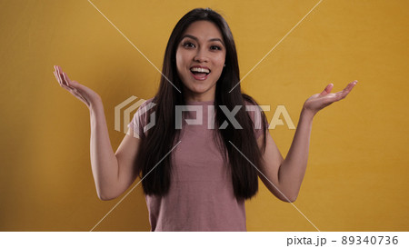 Portrait of a pretty girl against a yellow background 89340736