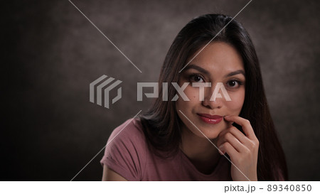 Close-up of a young woman with a satisfied facial expression 89340850