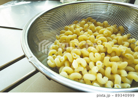 Fresh pasta in a stainless steel strainer Fresh pasta in a stainless steel strainer 89340999