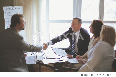 handshake of senior business partners on the Desk 89341871