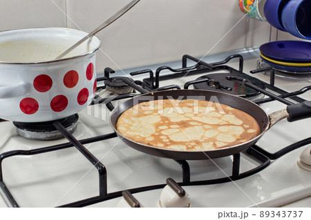 Cooking pancakes on Shrove Tuesday Cooking pancakes on Shrove Tuesday 89343737