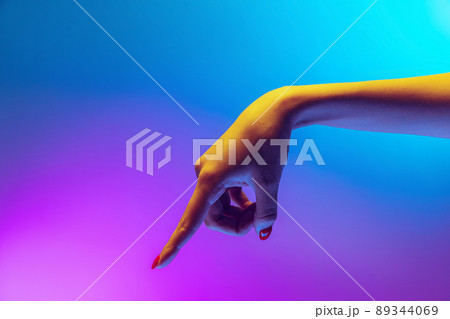 Studio shot of aethentic human hand isolated on gradient purple-blue background in neon light. Concept of human relation, community, togetherness 89344069