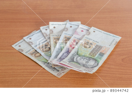 Croatian kuna banknotes (HRK) on wooden table. 89344742