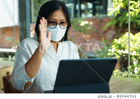 senior woman aged 60-69 years using tablet, watching lesson Sign language online course communicate by conference video call from home, e-learning education concept 89344743