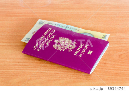 Polish biometric passport with 50 Romanian lei banknote (RON). 89344744
