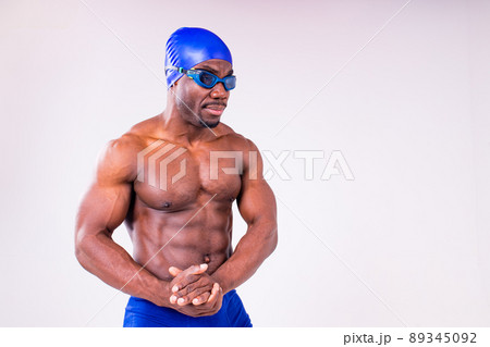 afro latin mixed race man swimmer getting ready to start swimming isolated on white background in studio 89345092