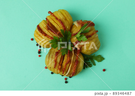 Baked potato with bacon on mint background 89346487