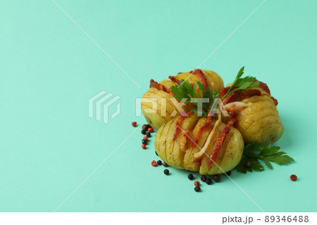 Baked potato with bacon on mint background 89346488
