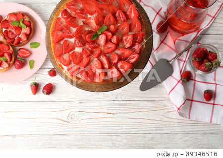 Concept of tasty food with strawberry tart on white wooden background Concept of tasty food with strawberry tart on white wooden background 89346516