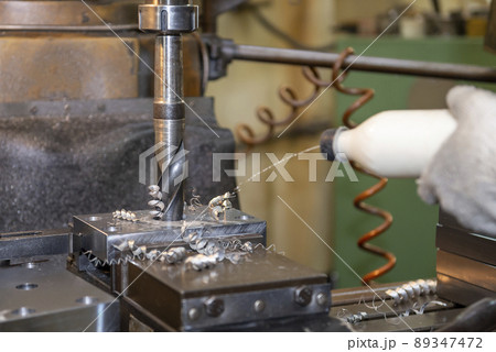 The machine operator between working with NC milling machine. The machine operator between working with NC milling machine. 89347472