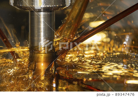 Close-up scene the CNC milling machine cutting the  mold parts with oil coolant method. 89347476