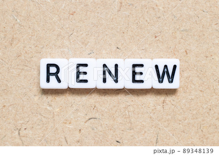 White tile alphabet letter with word renew on wood background White tile alphabet letter with word renew on wood background 89348139