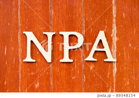 Alphabet letter in word NPA (Abbreviation of Non performing assets or Nasopharyngeal airway) on old red color wood plate background 89348154