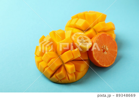 Ripe mango and orange on blue background 89348669