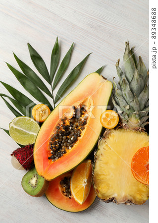 Ripe exotic fruits on white wooden background 89348688