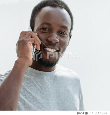 side view. stylish young man talking on his smartphone. side view. stylish young man talking on his smartphone. 89348999