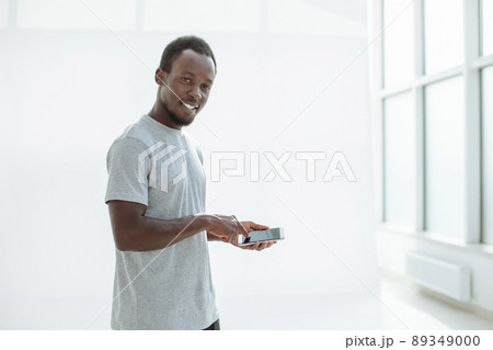 side view. stylish young man using his smartphone. side view. stylish young man using his smartphone. 89349000