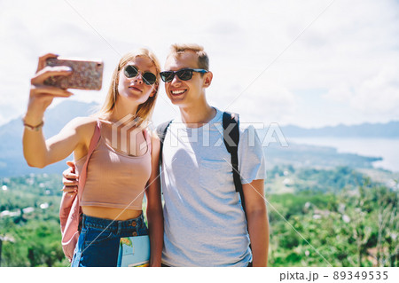 Couple of travelers taking selfie on smartphone Couple of travelers taking selfie on smartphone 89349535