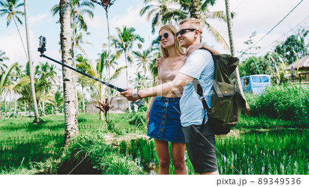 Cheerful couple taking photo in sunny day Cheerful couple taking photo in sunny day 89349536