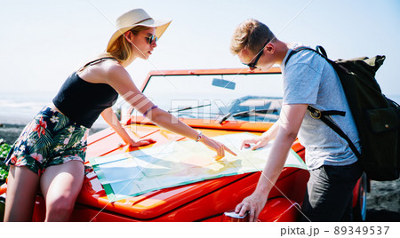 Couple of tourists finding way using map Couple of tourists finding way using map 89349537