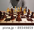 Man analyzing chess game on chess board - strategic concept. 89349859