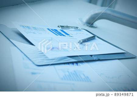 pen and financial documents on the desktop in the office 89349871