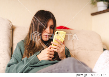 Woman with laptop and phone Woman with laptop and phone 89350187