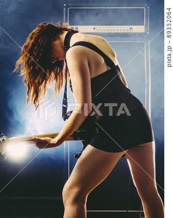 Beautiful sexy woman playing electric guitar 89352064
