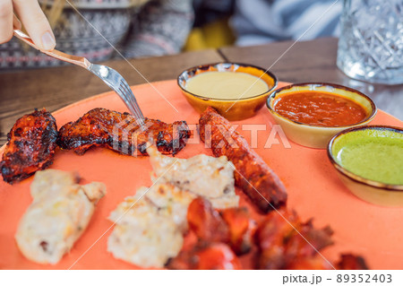 Indian cuisine-Famous Indian mutton or lamb curry dish in a cast iron cookware. Selective focus photograph Indian cuisine-Famous Indian mutton or lamb curry dish in a cast iron cookware. Selective focus photograph 89352403