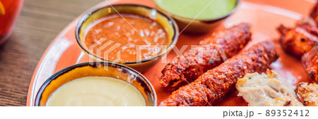 Indian cuisine-Famous Indian mutton or lamb curry dish in a cast iron cookware. Selective focus photograph BANNER, LONG FORMAT 89352412