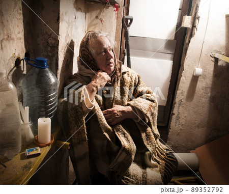 Frightened woman hide from explosions in the basement. During the sirens due to the shelling of Kyiv. Ukraine. 26 February 2022 Frightened woman hide from explosions in the basement. During the sirens due to the shelling of Kyiv. Ukraine. 26 February 2022 89352792