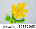 Yellow flower with green leaves. Multi-colored children drawing 89352965