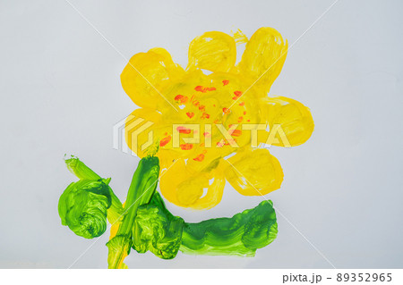Yellow flower with green leaves. Multi-colored children drawing 89352965
